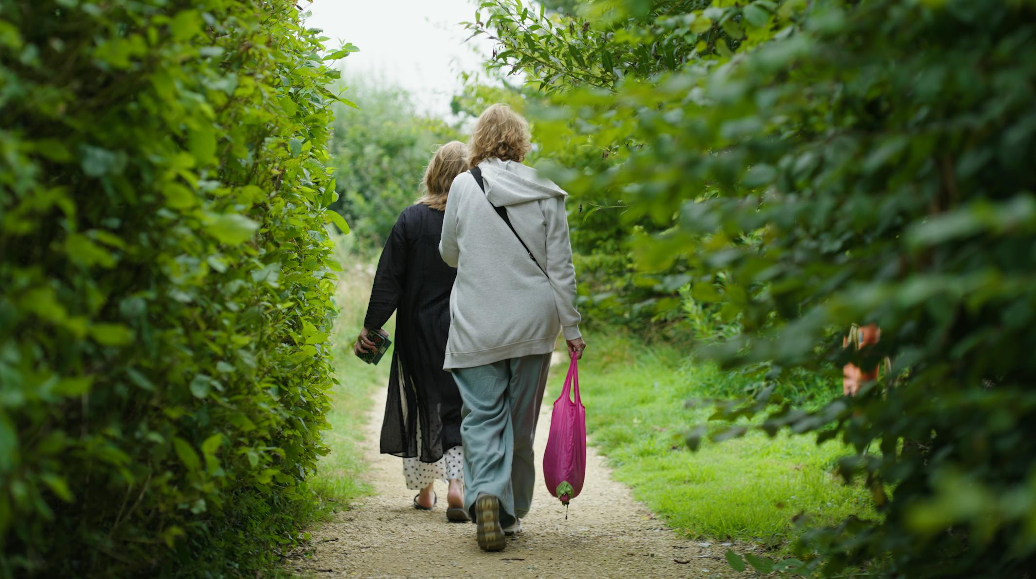 Sculpture by the Lakes - ladies walking through greenery