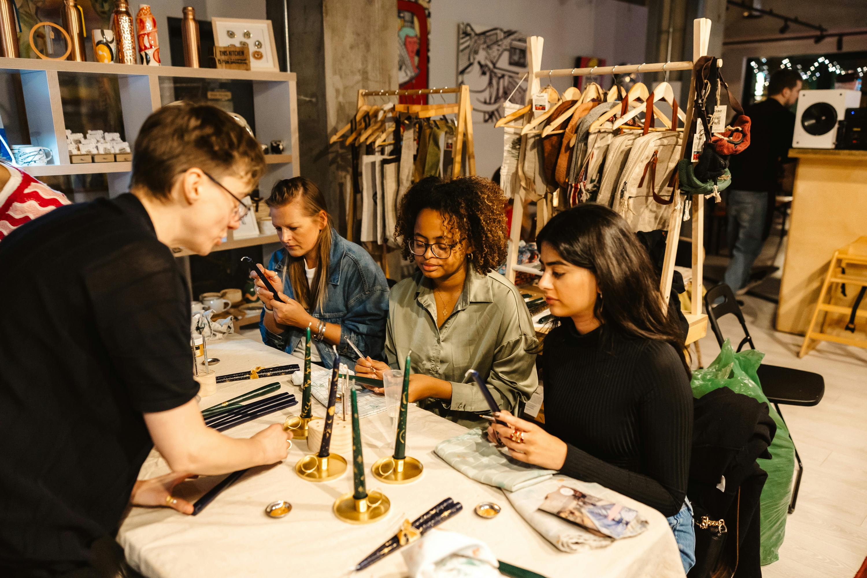 Lou wildflowers of london event teacher showing three people how to paint candles