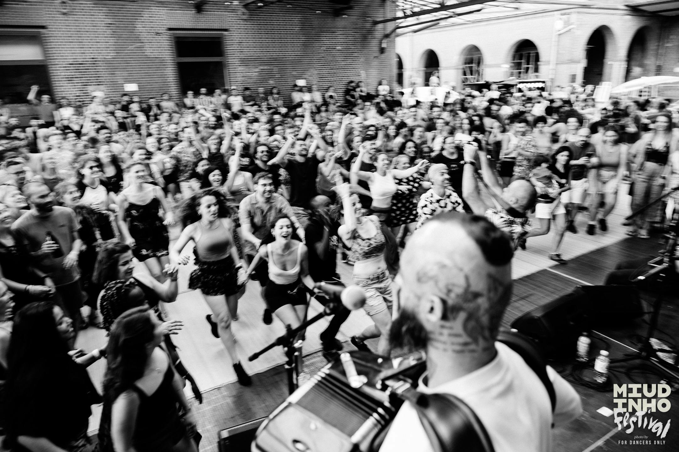 Black and white image of people dancing at Miudinho Festival