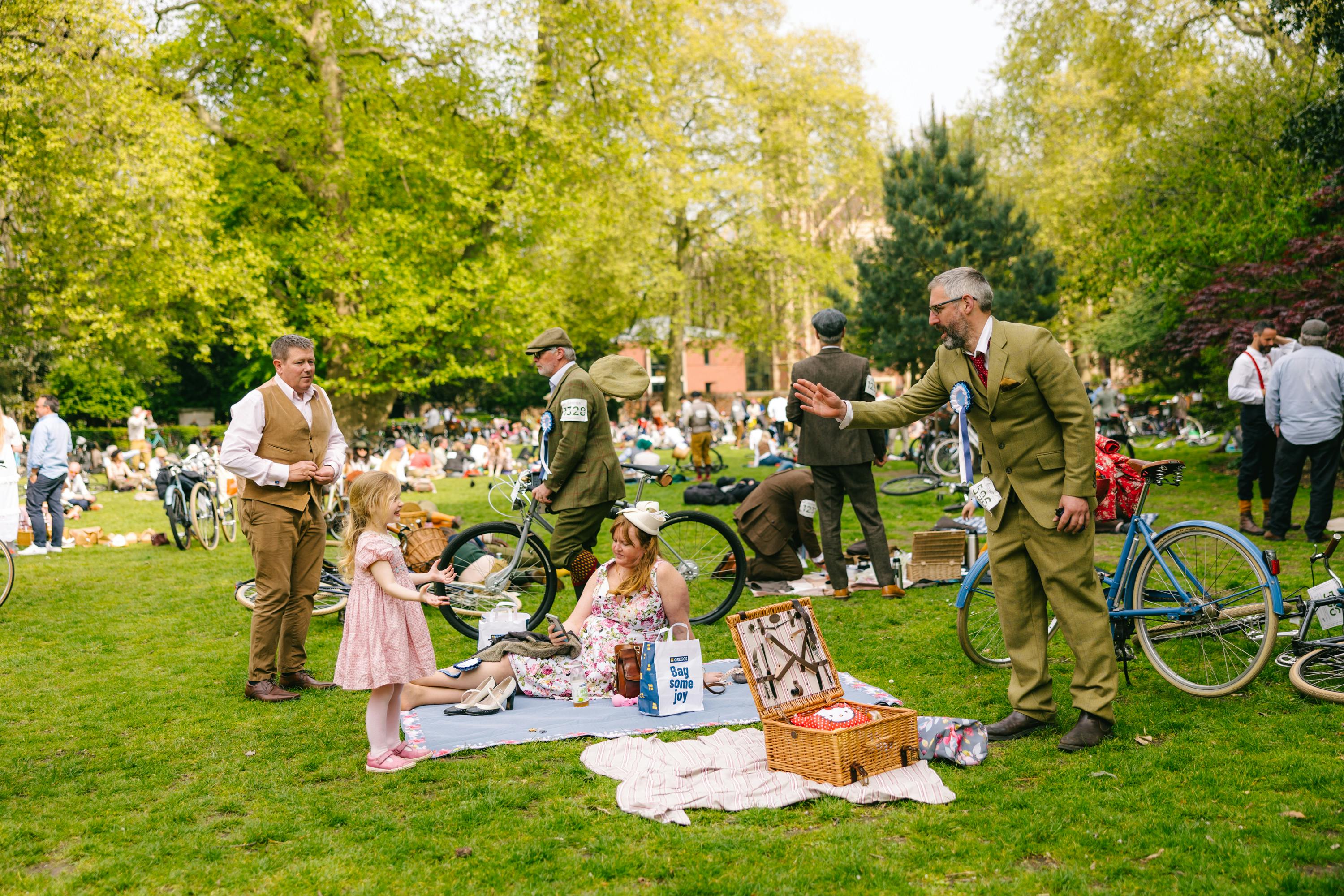 The Tweed Run Family at picnic with kids playing by bikes