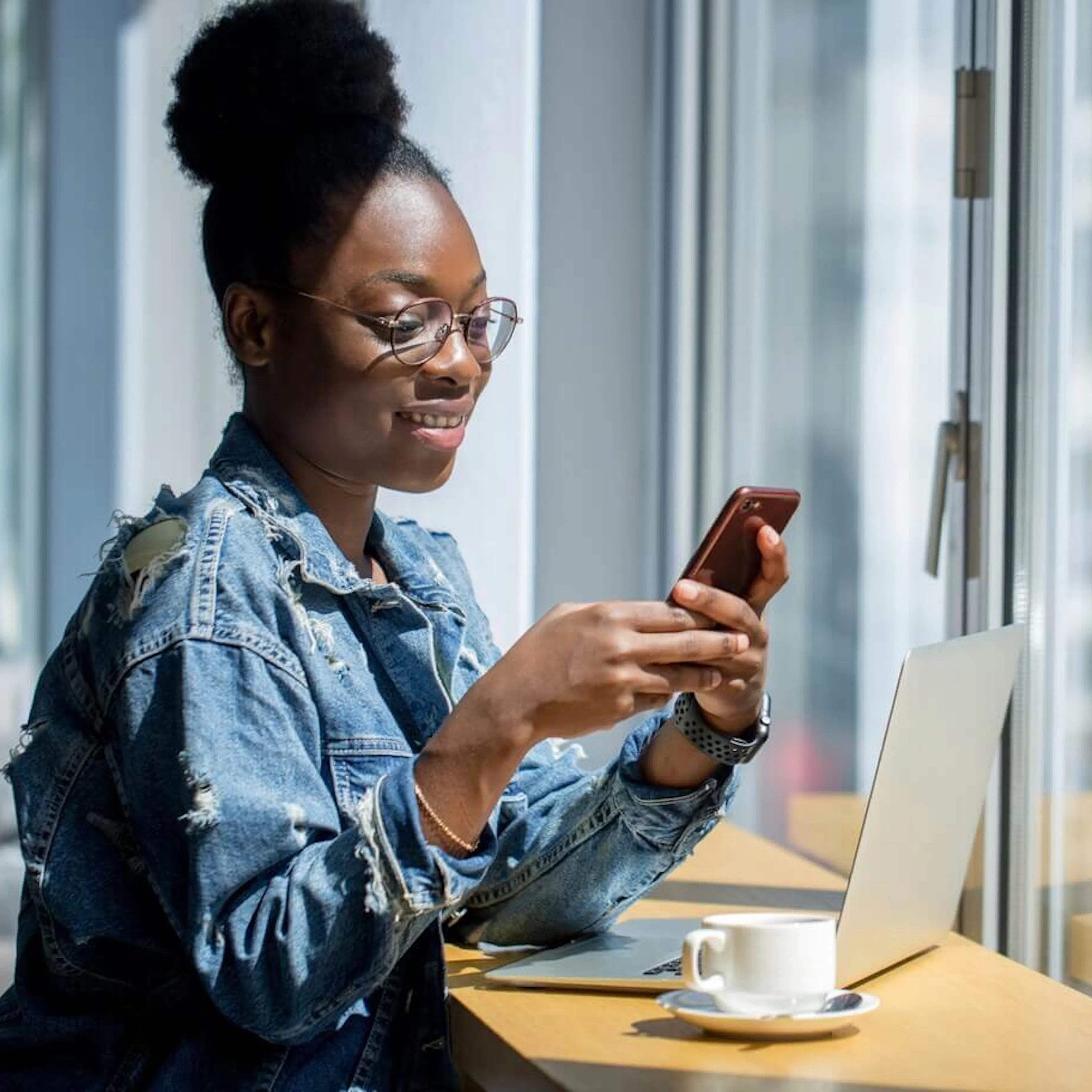 Woman working on laptop and phone