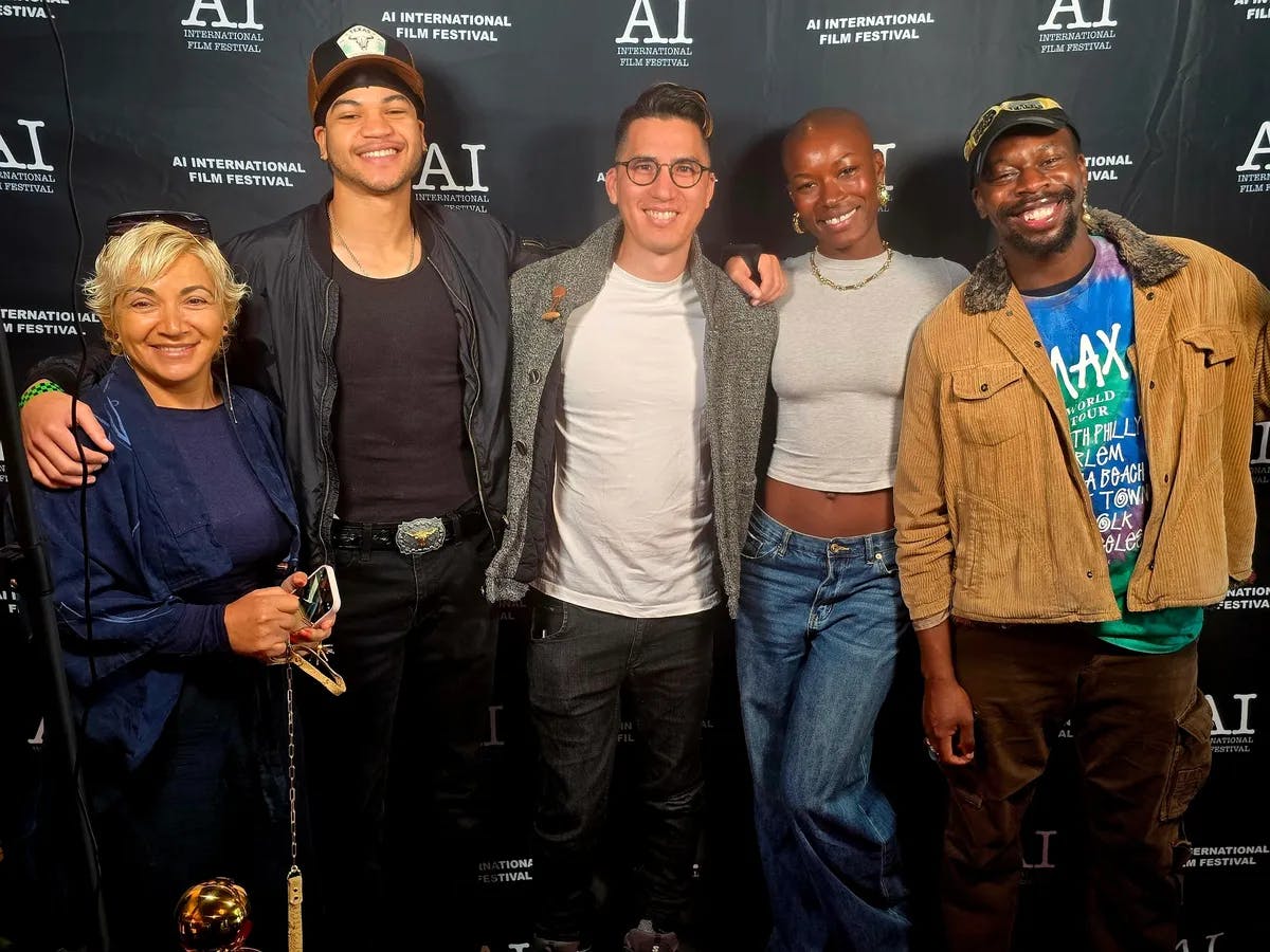 5 people posing for a press photo with an 'AI International Film Festival' backdrop