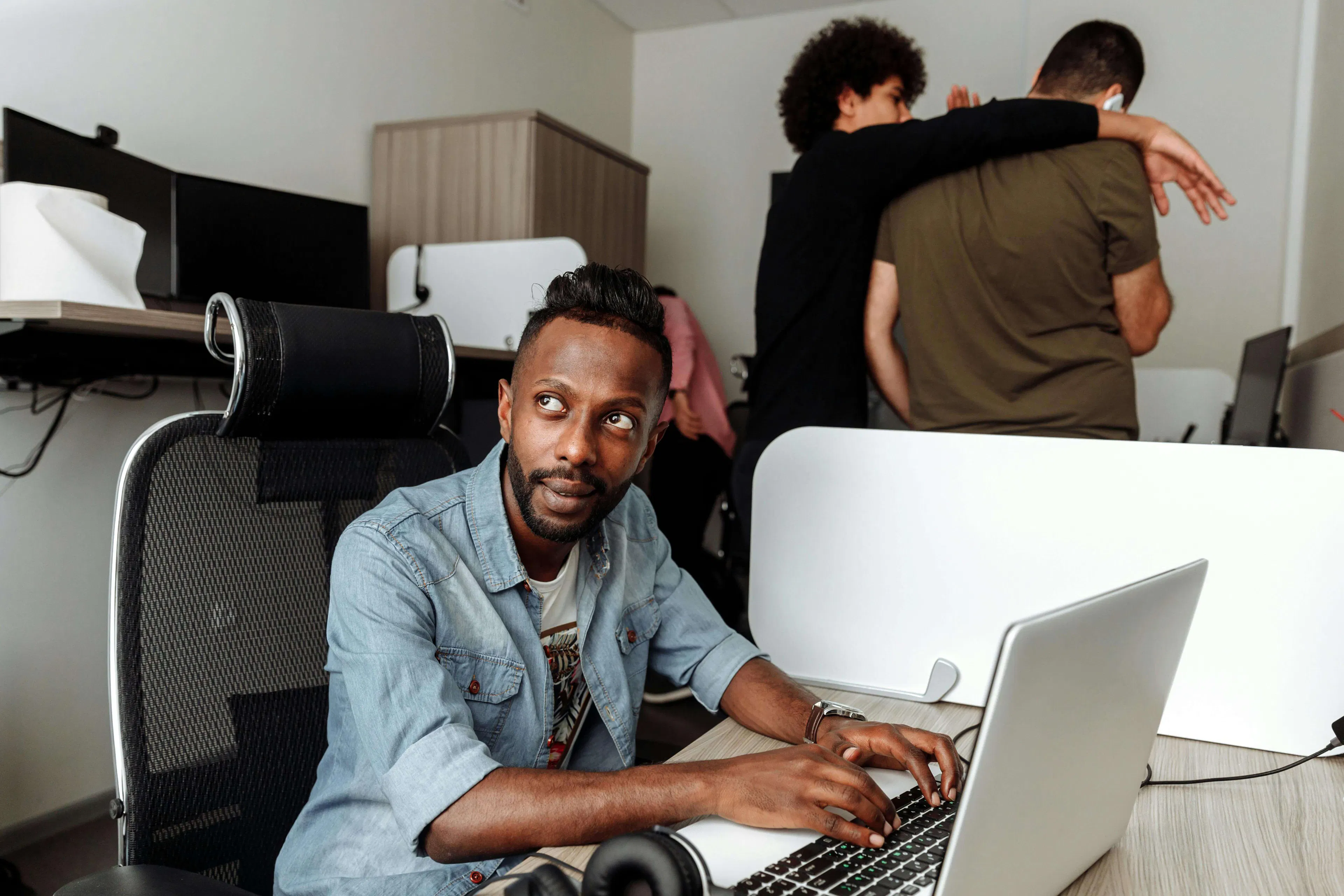 Man working at laptop and looking up