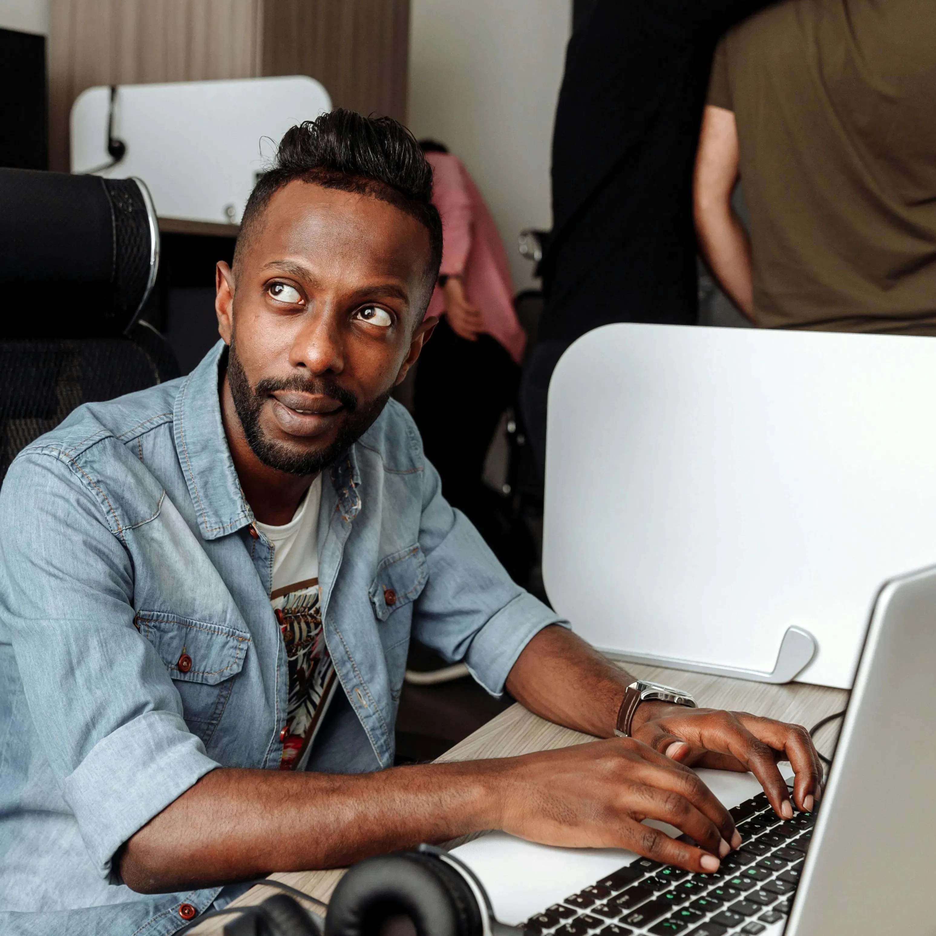 Man working at laptop and looking up
