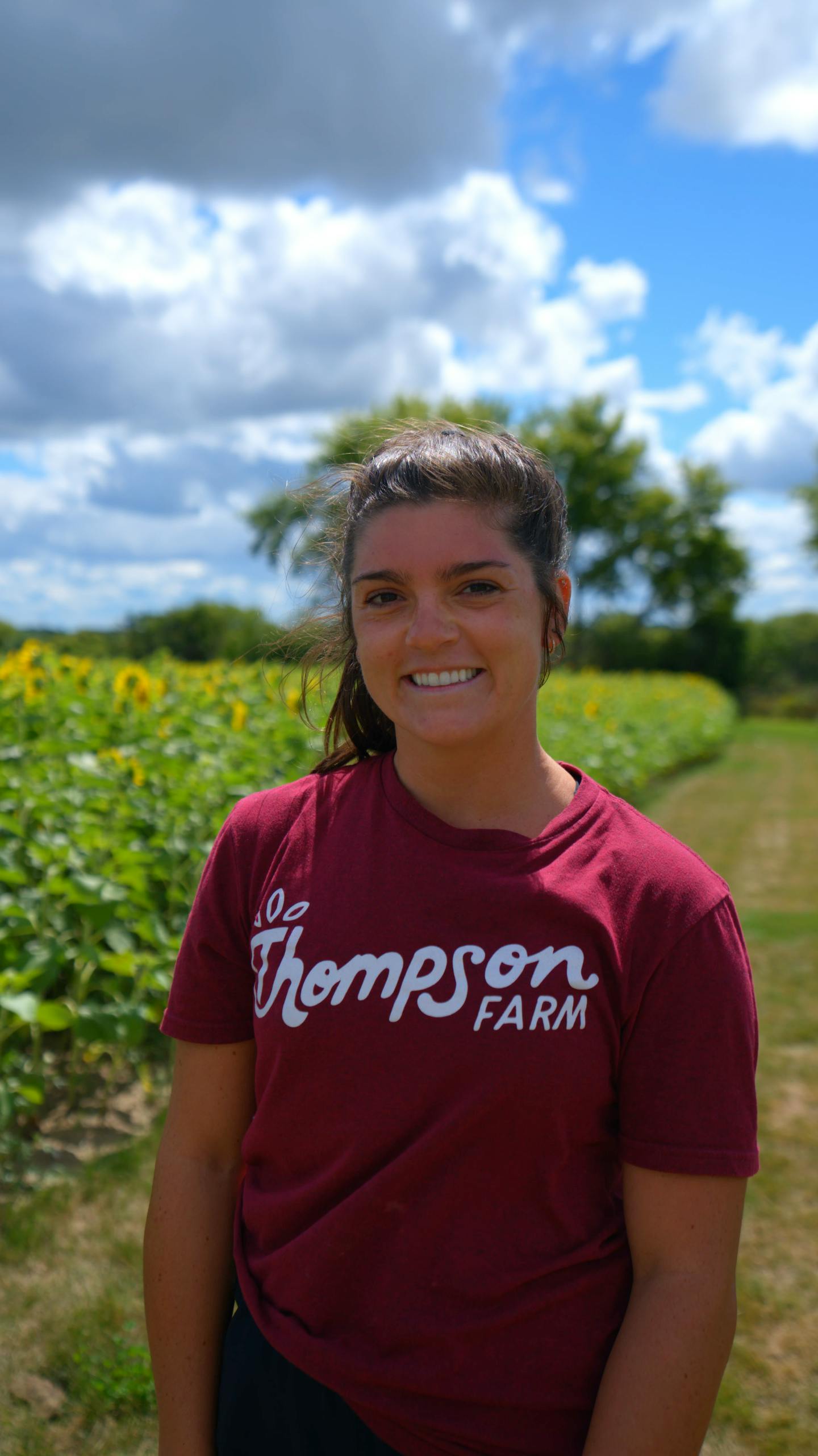 lady in sunflower field with red t-shirt on