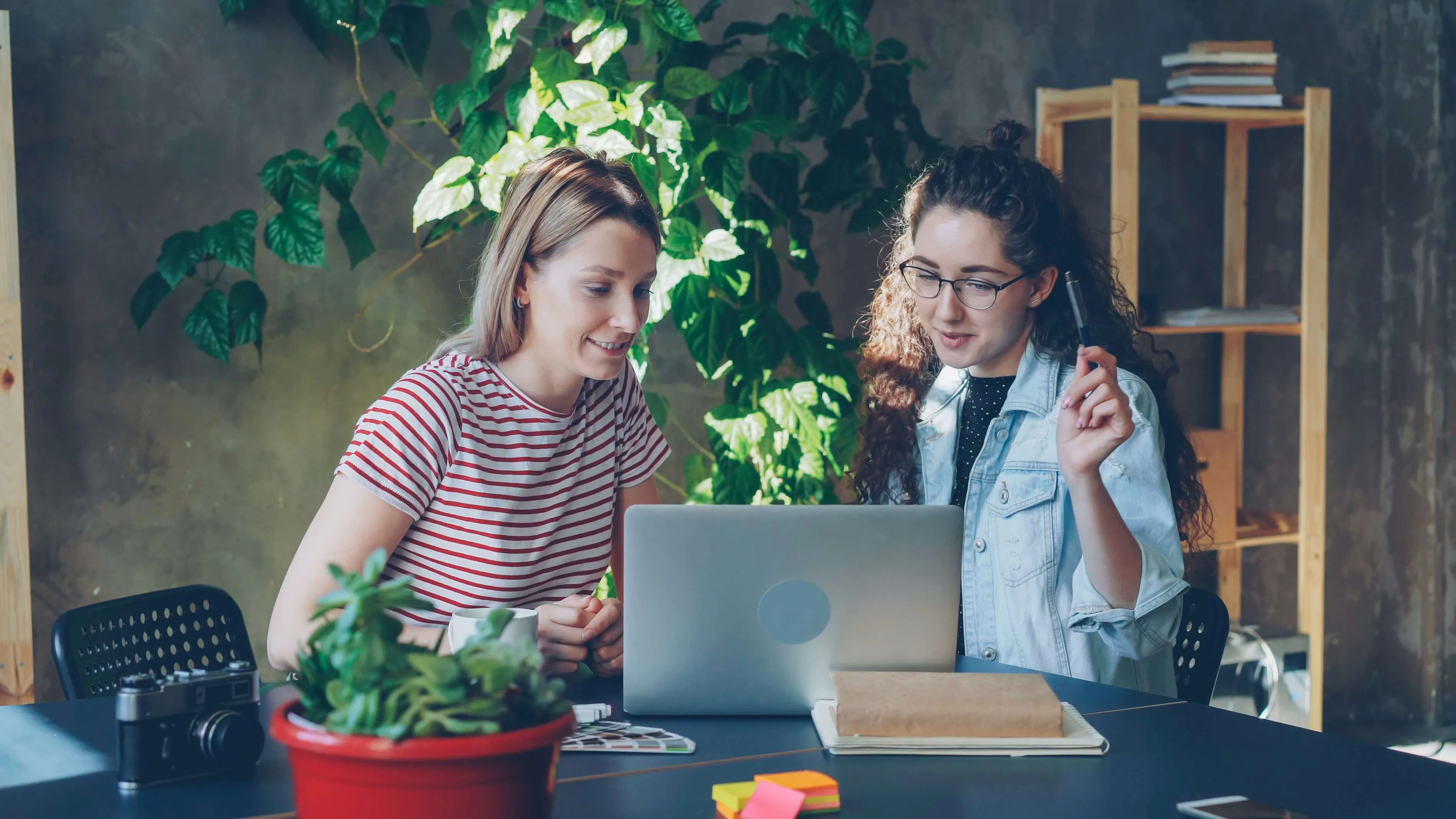 2 people working on a laptop