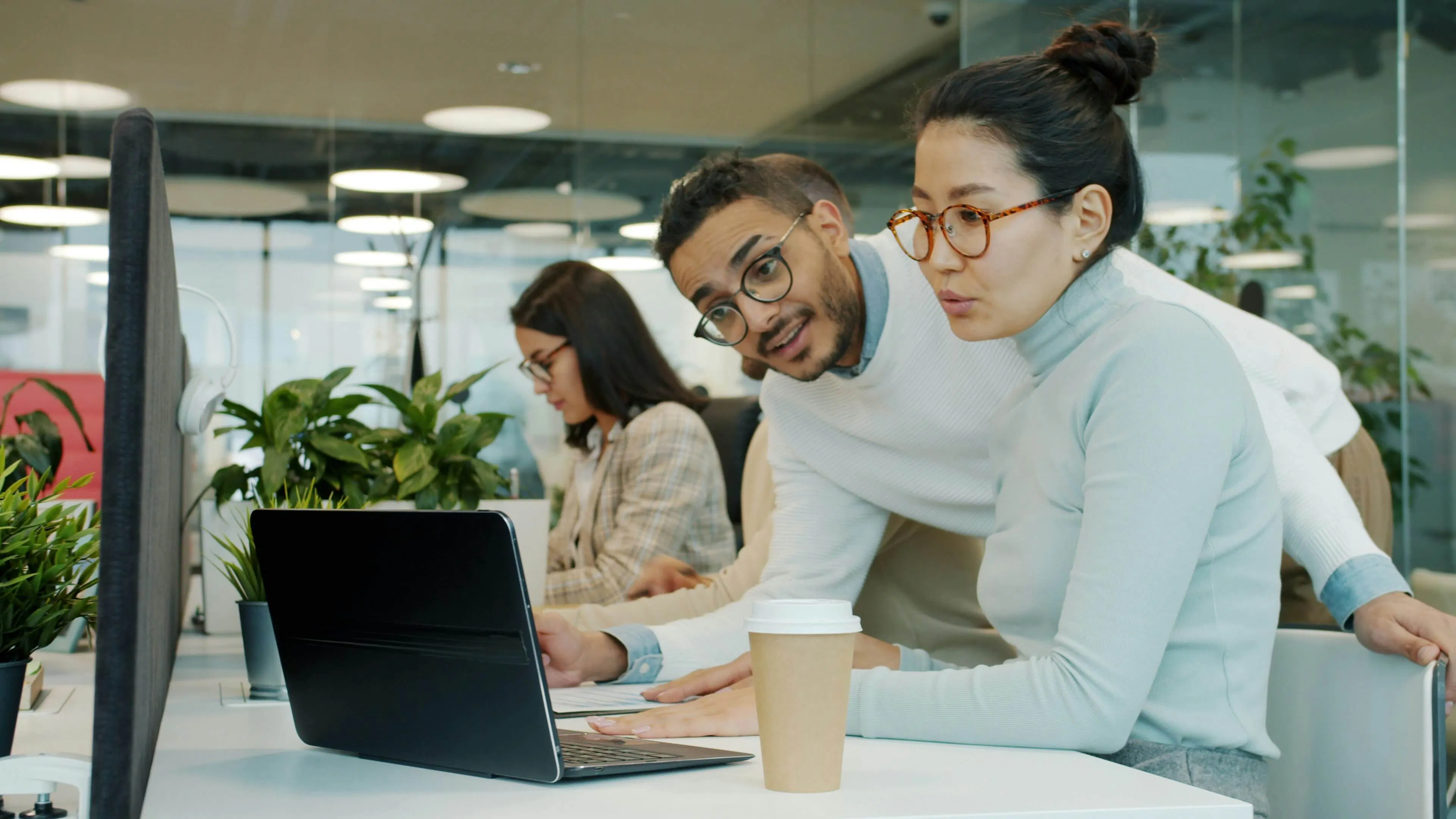 2 people working on laptop