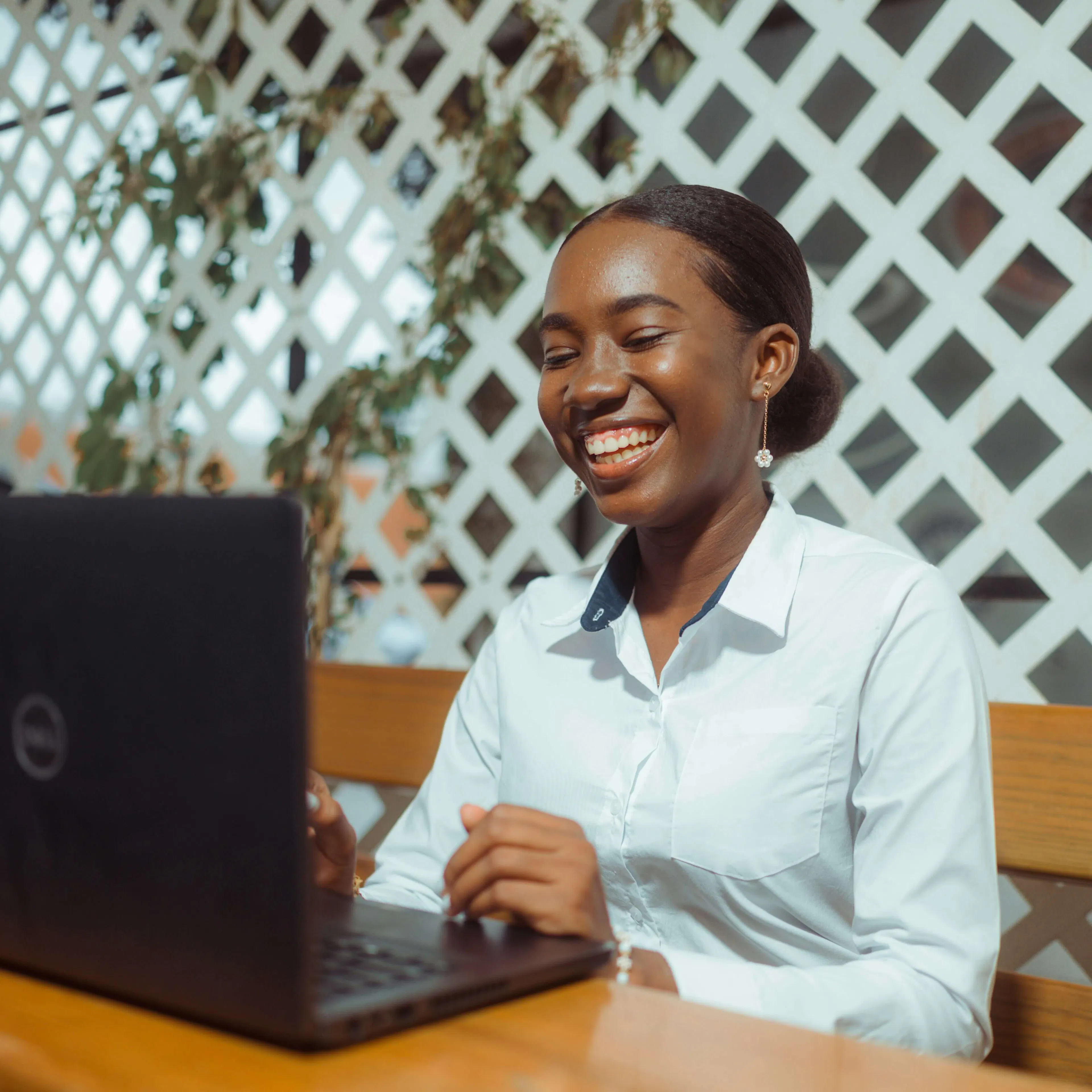 woman smiling while working on laptop
