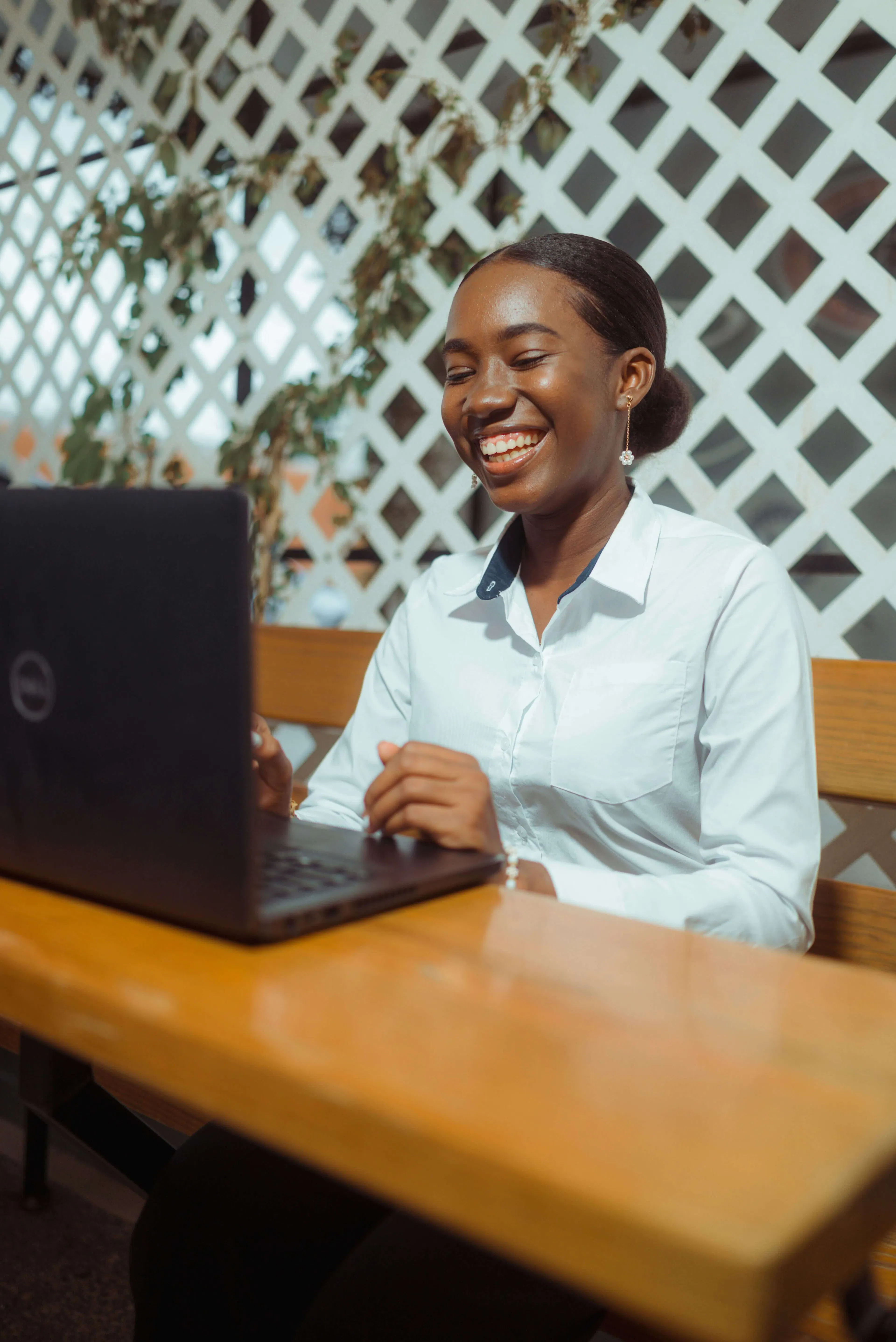 woman smiling while working on laptop