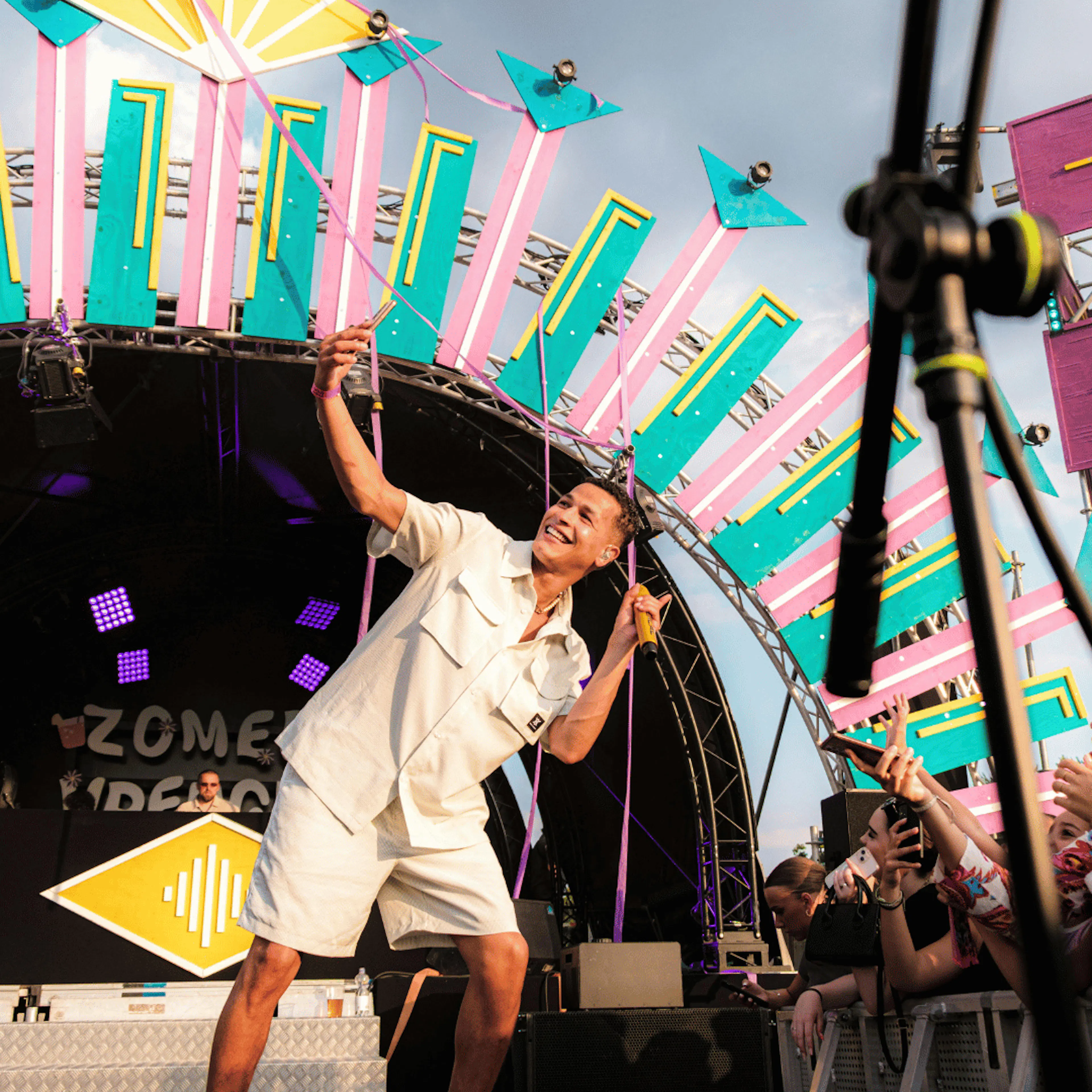 man on stage at festival